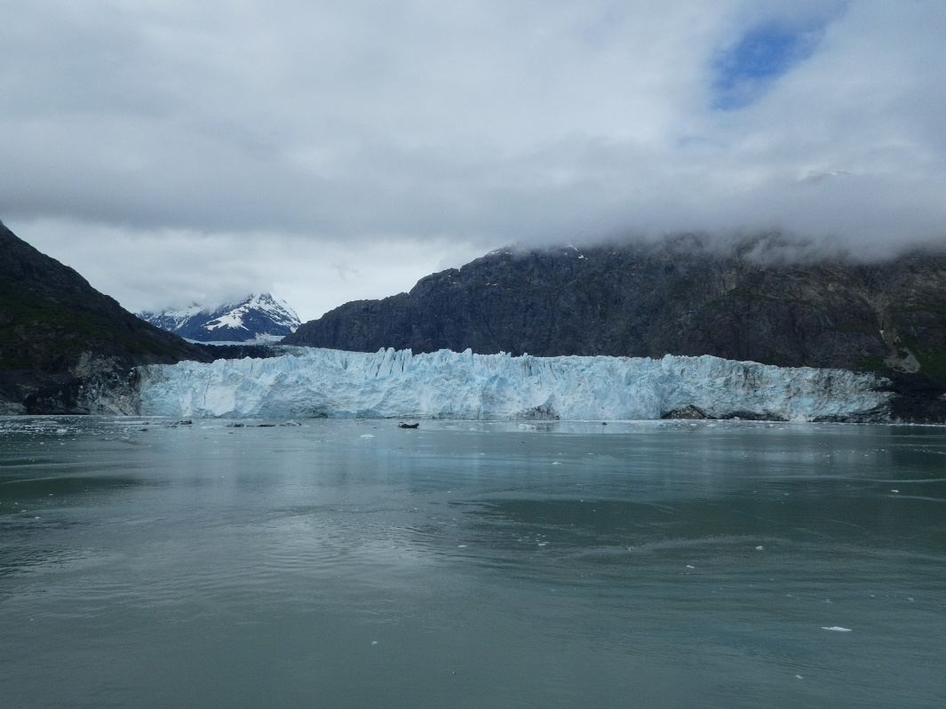 A body of water with mountains in the background Description automatically generated with medium confidence