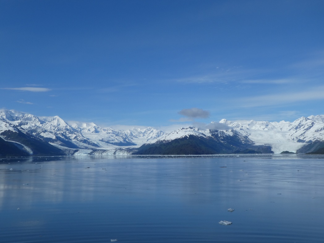 A body of water with snow covered mountains in the background Description automatically generated with medium confidence