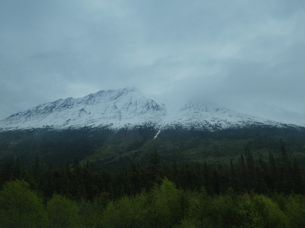 A picture containing outdoor, sky, mountain, grass Description automatically generated